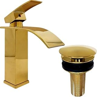Torneira dourada moderna com design elegante e bico baixo, acompanhada de ralo de pia dourado, fundo branco.